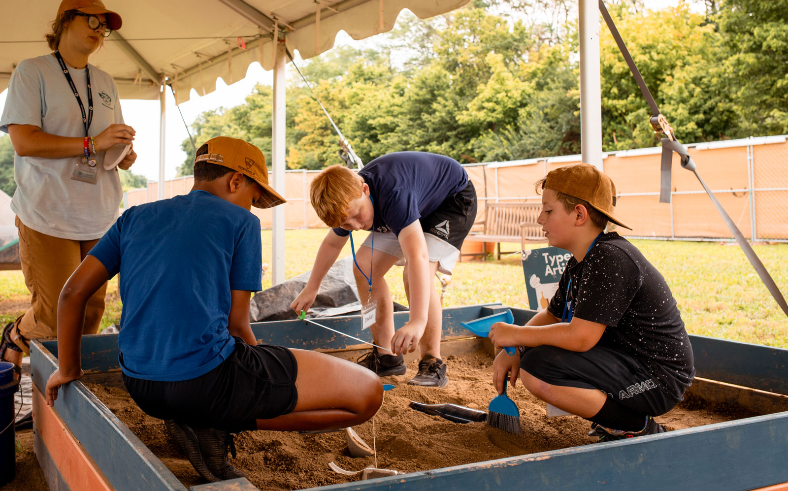 three teens boys participating in dig event at Archaeological Research Institute