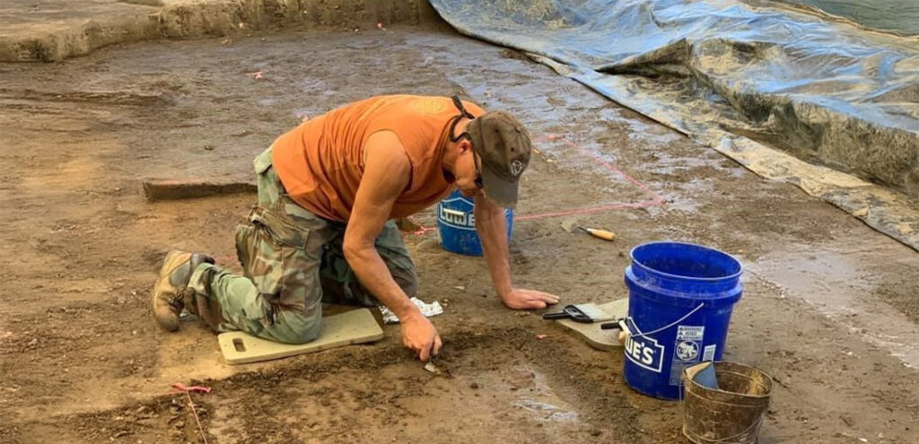 man digging during a field experience at Archaeological Research Institute (ARI)