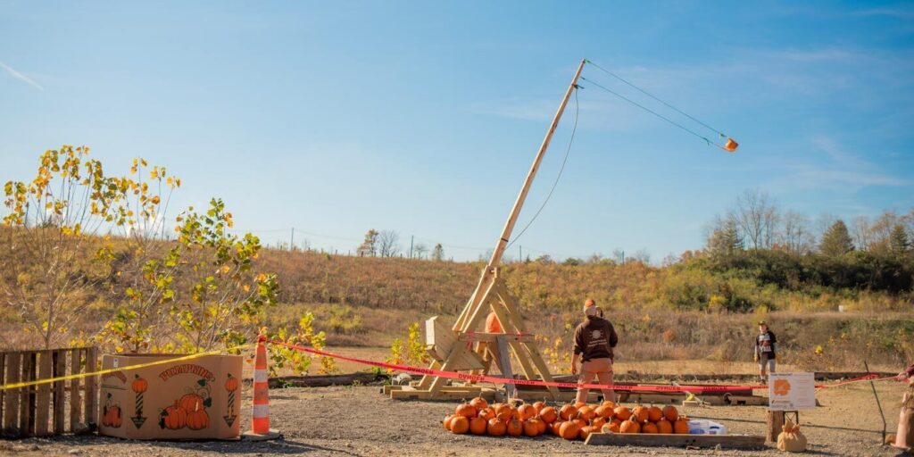 19-foot trebuchet launching a pumpkin at ARI’s Pumpkin STEM Fall Festival.