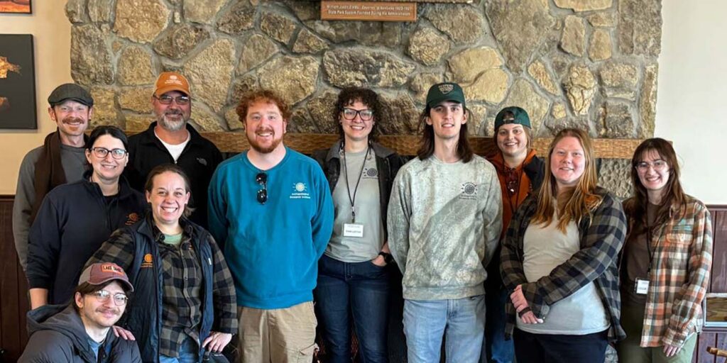 Archaeologists from the Archaeological Research Institute posing for a group photo during a conference