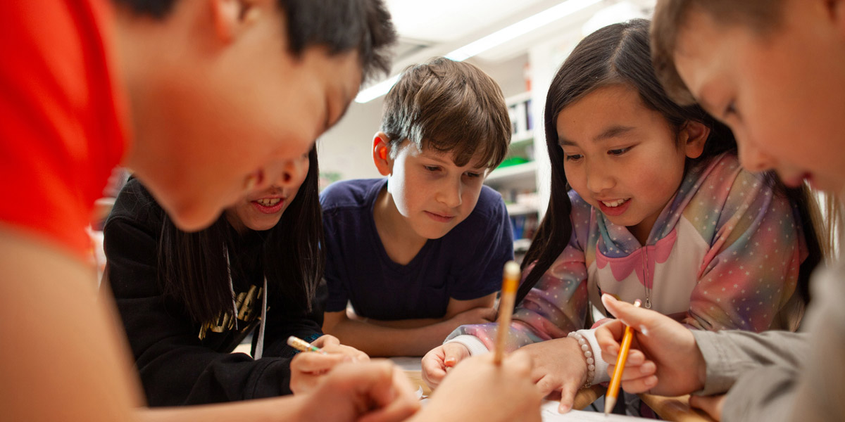 Students engaged in an ARI archaeology-inspired classroom activity with pencils and paper