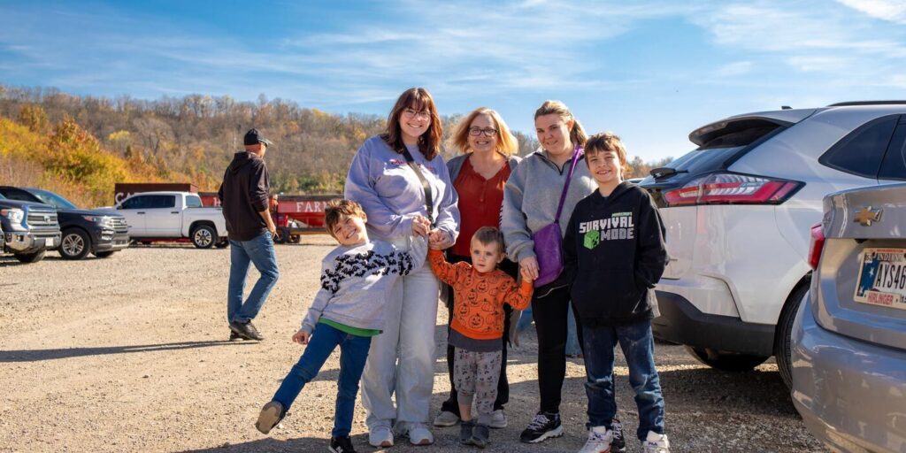 Family smiling outside of ARI's annual pumpkin STEM event